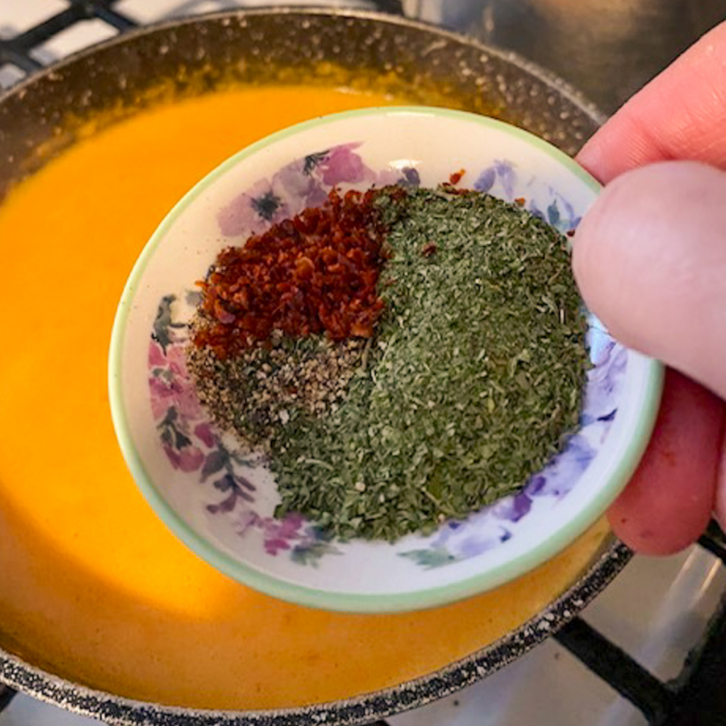 spices being added to a dish